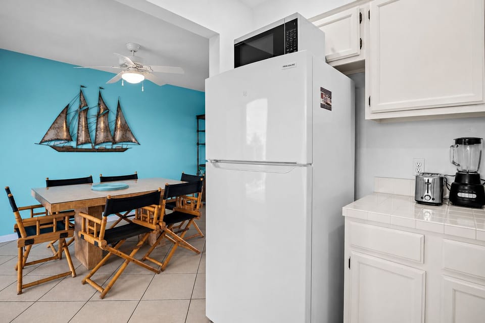 Full-size fridge and everything you need to stock up for the week, with the dining area just around the corner.