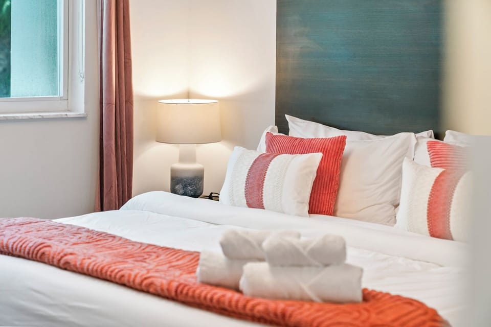 Cozy king bedroom with plush pillows and luxe linens. Darkening shades guarantee restful sleep, plenty of storage, and a smart TV for your favorite shows.