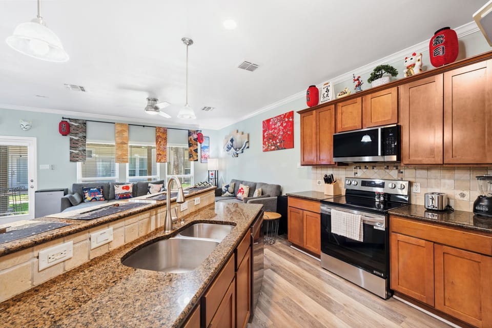 Step into your well-appointed kitchen where granite countertops, stainless steel appliances, and an open layout invite you to prepare meals while staying connected with loved ones in the adjoining living space.