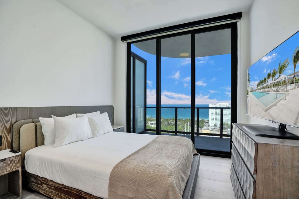 Sun-drenched master bedroom with private balcony access