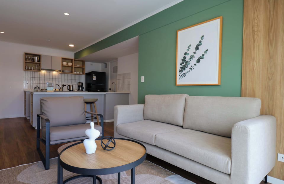 Inviting living space with contemporary furniture and green accent wall
