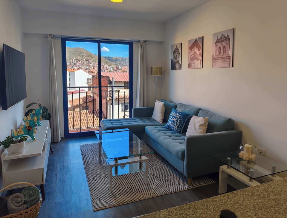 Cozy living room with balcony and city views.

