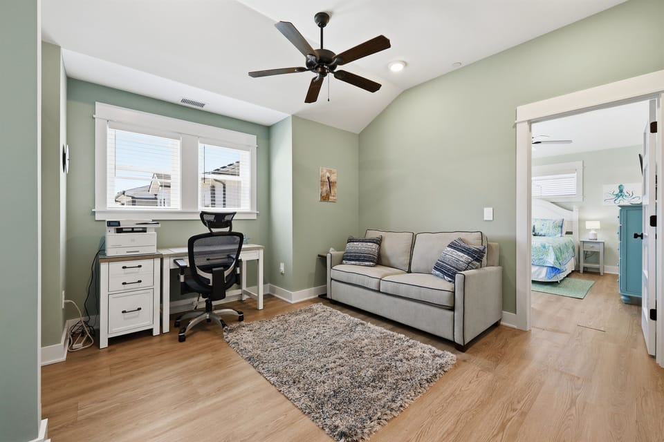 Bonus sitting area and workspace with sleeper sofa for additional guests