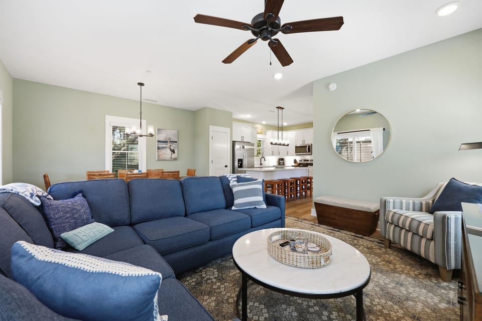 Comfortable sectional sofa and open layout connecting the kitchen and dining area