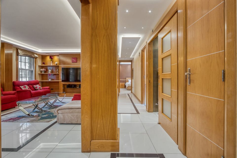 Generous hallway connecting the living space to three private bedroom wings — 1,331 sq ft on a single floor giving every guest their own space.