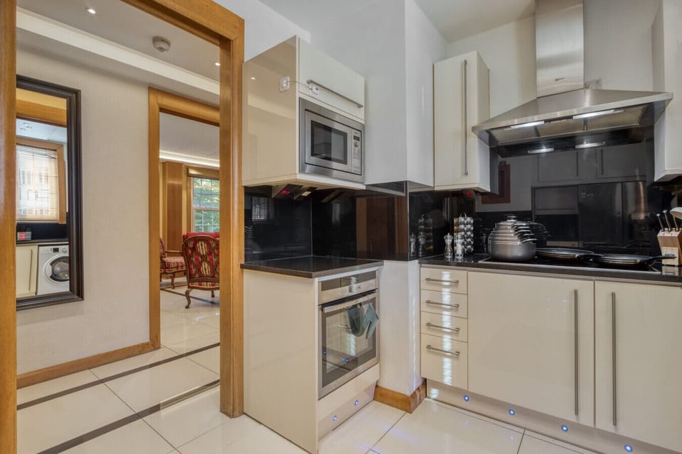 Kitchen with built-in oven, microwave and induction hob — open doorway to the living room keeps the group connected while cooking.