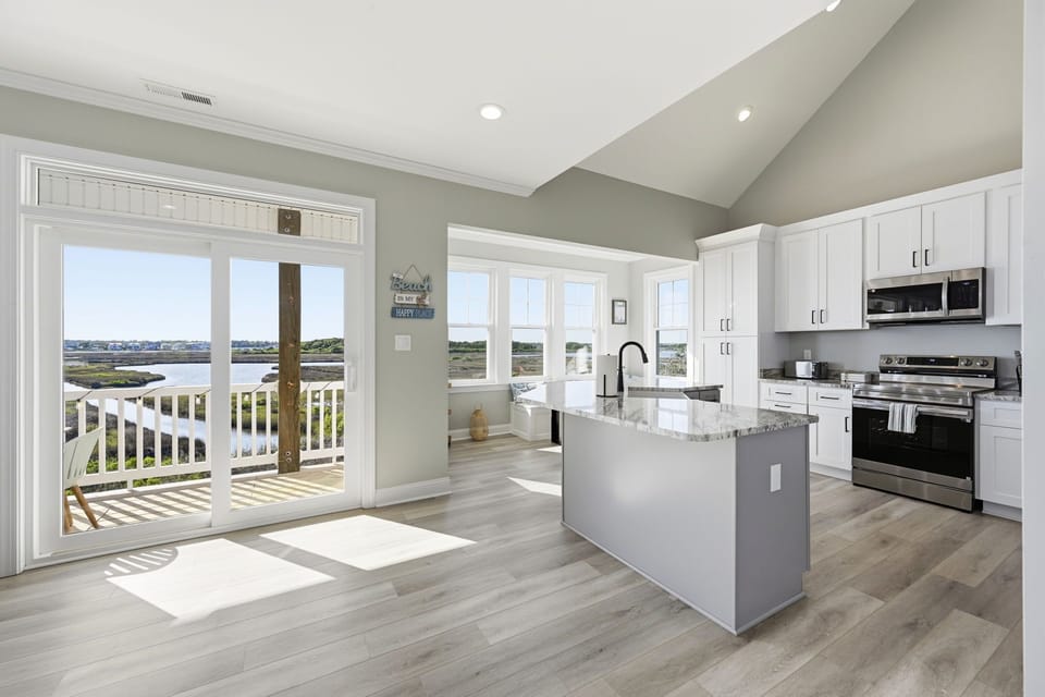 A modern kitchen with beautiful natural light and views around every corner