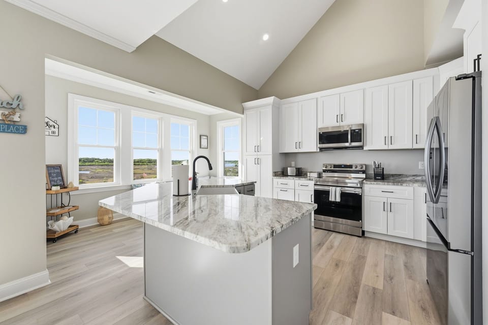 Clean coastal design and a spacious island make this kitchen perfect for group stays