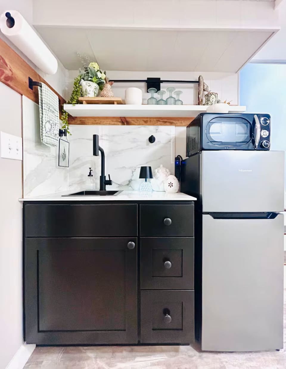 Kitchenette with microwave, refrigerator, and two burner hotplate.