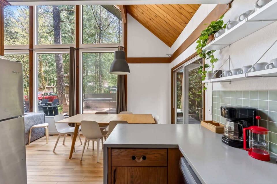 Kitchen and dining area with forest views.