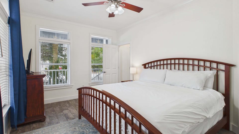 Primary guest bedroom with king bed and TV + ensuite bathroom (sleeps 2)