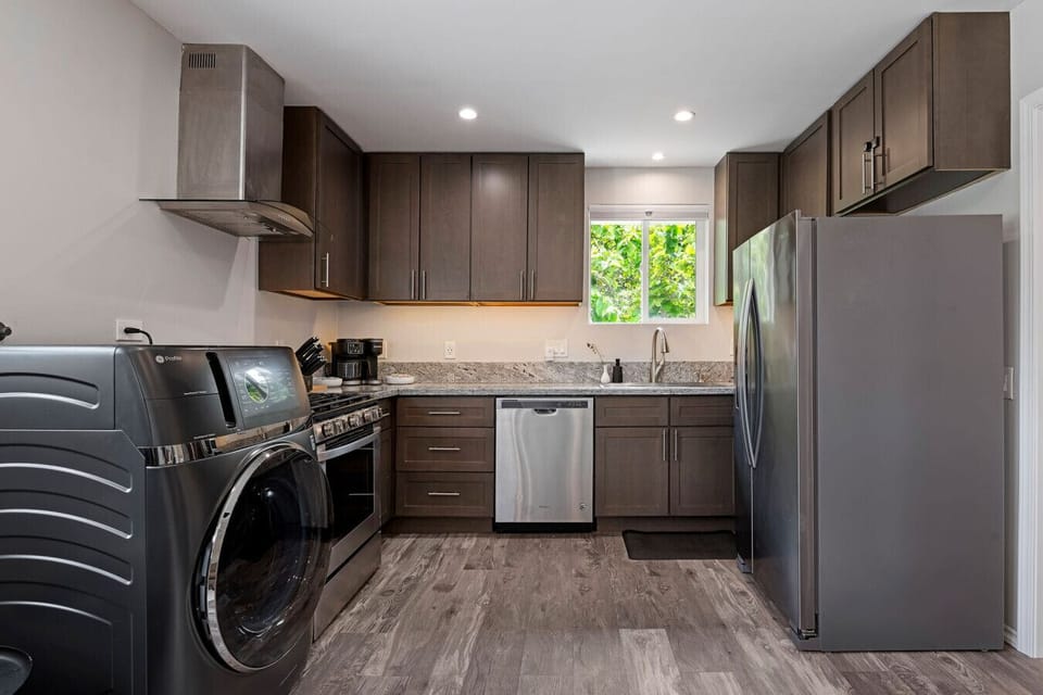 Fully equipped kitchen with stainless appliances and in-unit all in one washer/dryer