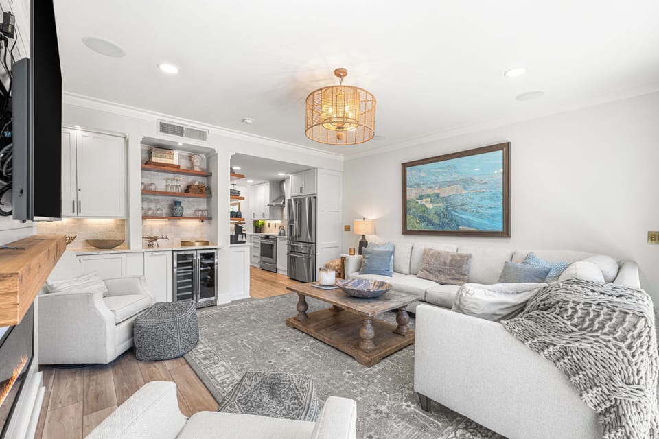 The living room shows its connection to the kitchen and dining areas.