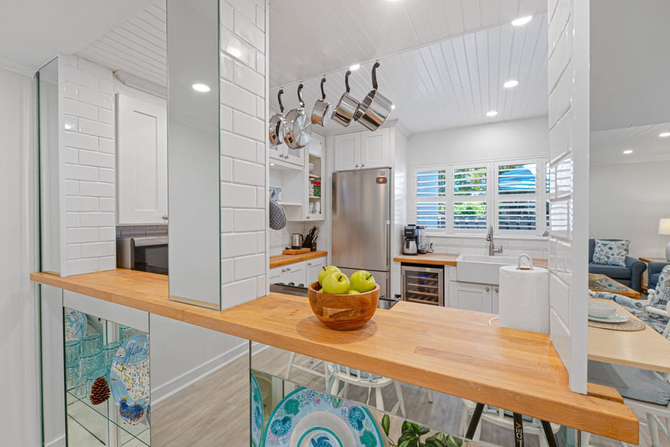 Updated kitchen featuring stainless steel appliances, coastal-inspired finishes.