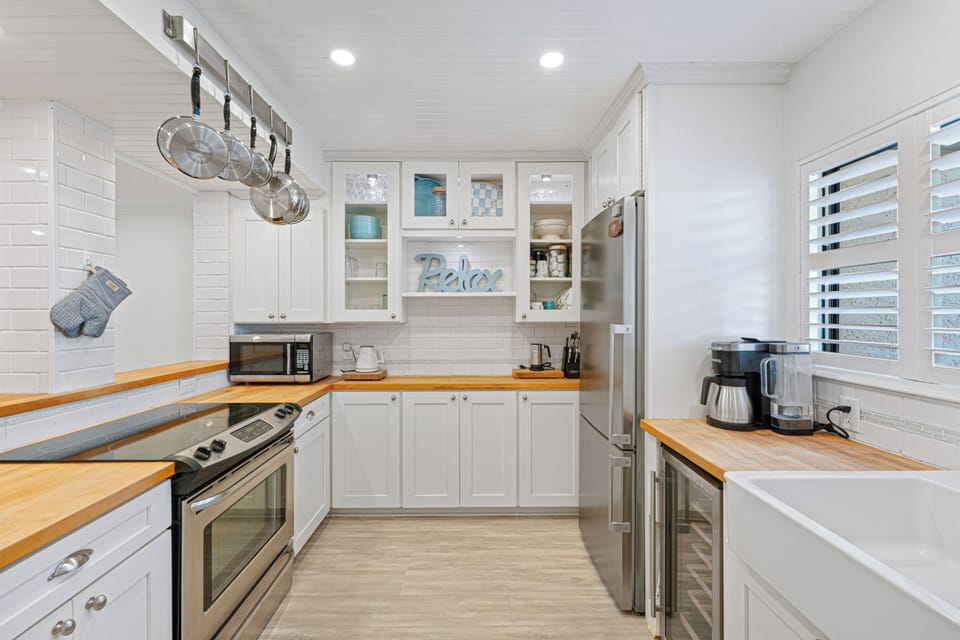 Updated coastal kitchen with stainless steel appliances.