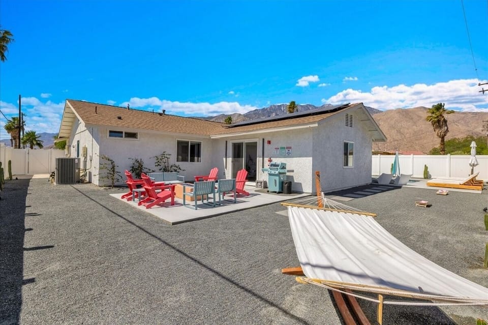 Spacious backyard with pool, fire pit lounge, hammock, and BBQ