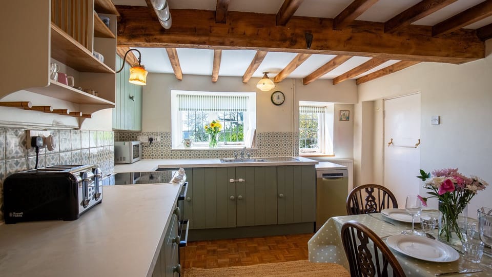 The kitchen has pretty views of the garden and hills beyond