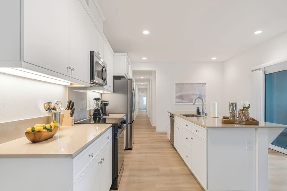 Sleek shaker-style cabinetry provides ample storage for all your culinary needs.