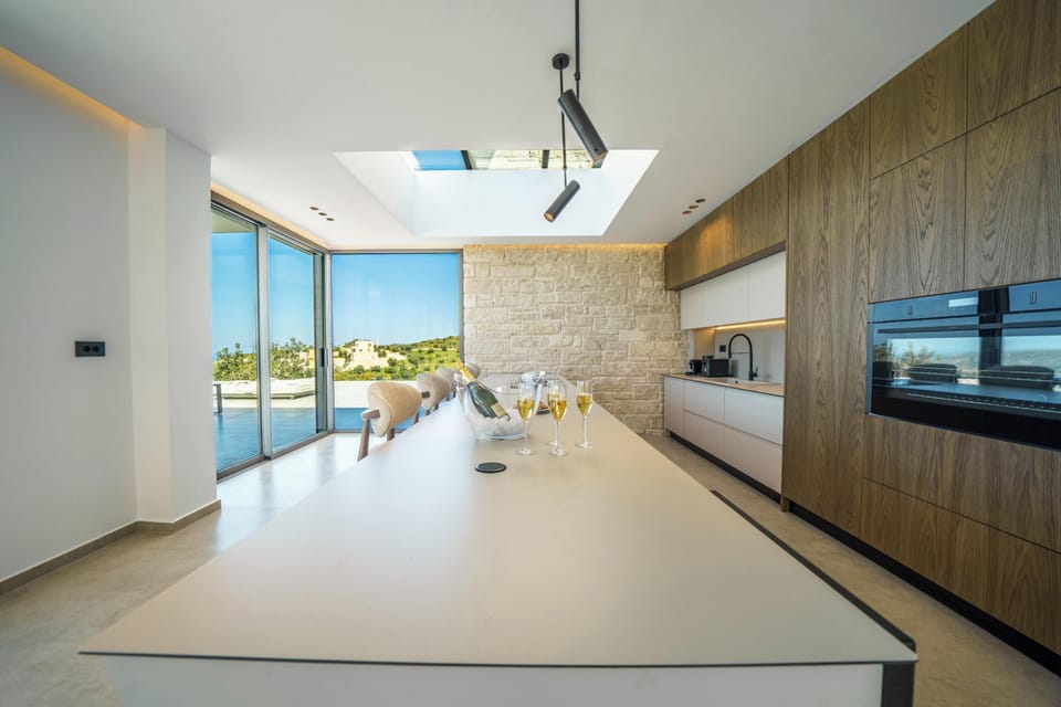 The fully equipped kitchen includes all modern appliances for a seamless self-catered stay, complemented by a skylight that fills the space with sunlight