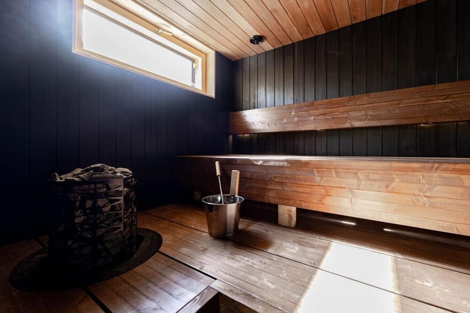 Experience authentic Finnish relaxation in our private, designer sauna featuring traditional tiered seating and a high-capacity heater. It’s the perfect way to soothe your muscles and warm up after a day of arctic adventures.