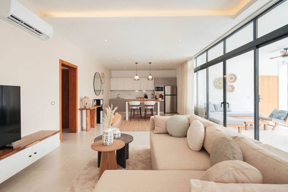 Bright and comfortable living room with a fully equipped kitchen and easy access to the balcony.
