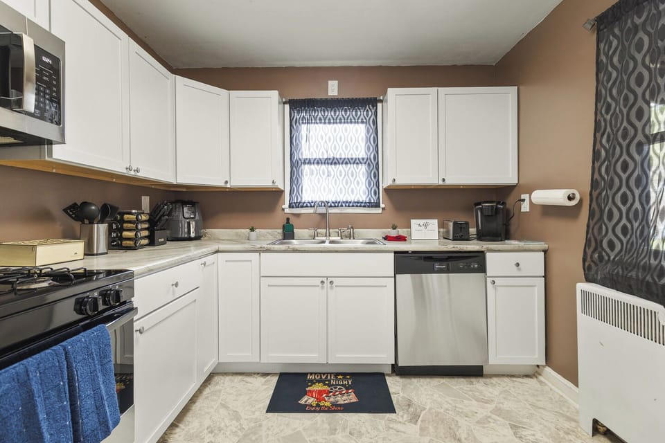 Bright, fully equipped kitchen with gas range, dishwasher & coffee bar.