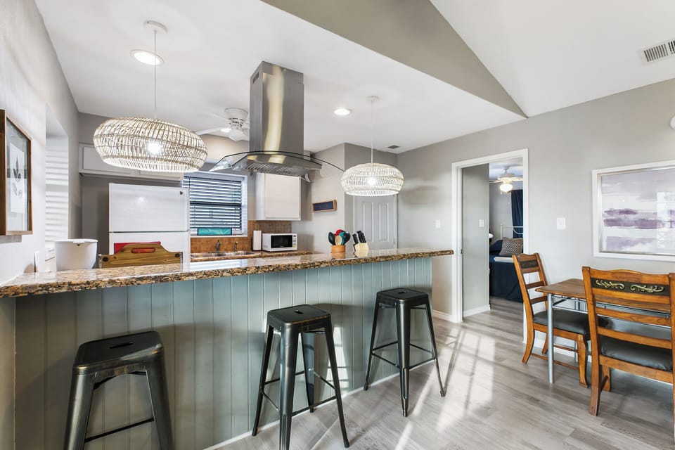 Fully equipped kitchen with modern appliances and breakfast bar