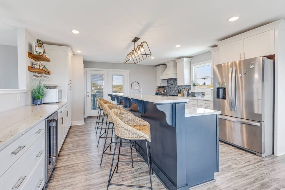 Spacious kitchen island with seating for 5 and an added prep sink for easy entertaining.