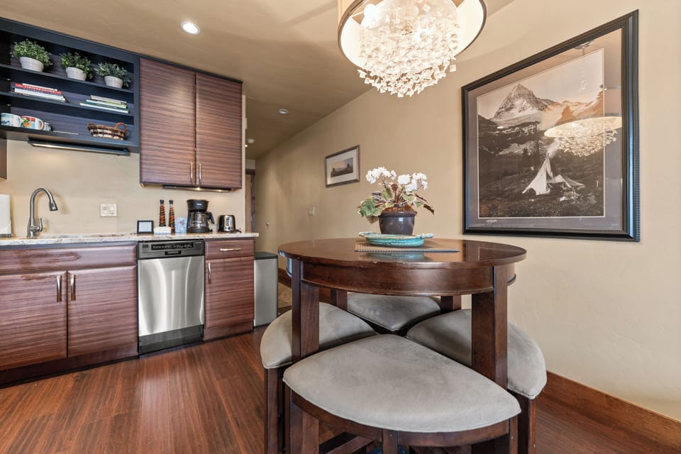 Gather around your cozy dining table under a stunning chandelier, with a fully-equipped kitchen ready for preparing meals and creating lasting memories together.