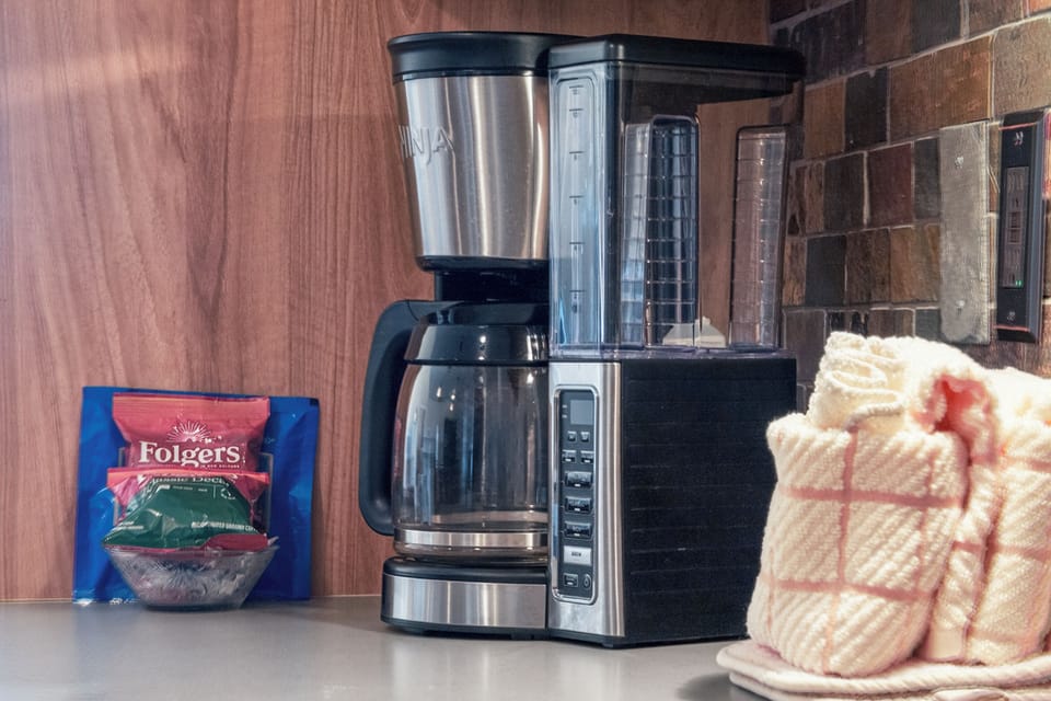 Start your mornings right with freshly brewed coffee from your dedicated station, complete with premium Folgers and cozy linens.