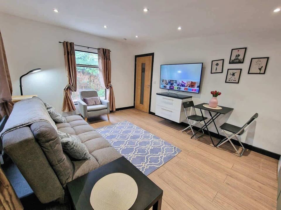 Relaxing living area with smart TV, gallery wall, and space to unwind after a day exploring