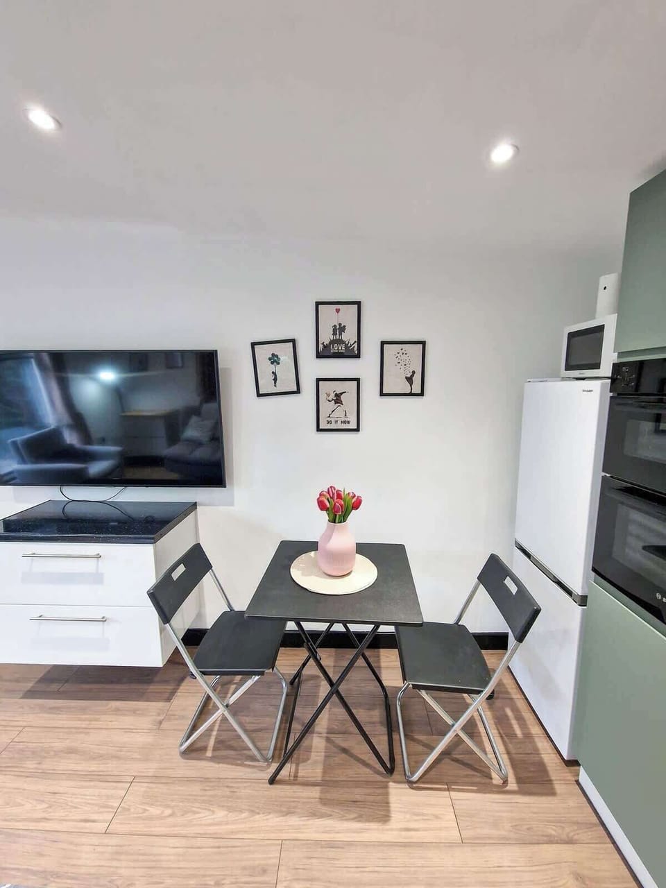 Modern kitchen with dining table, fully equipped for cooking meals during your stay