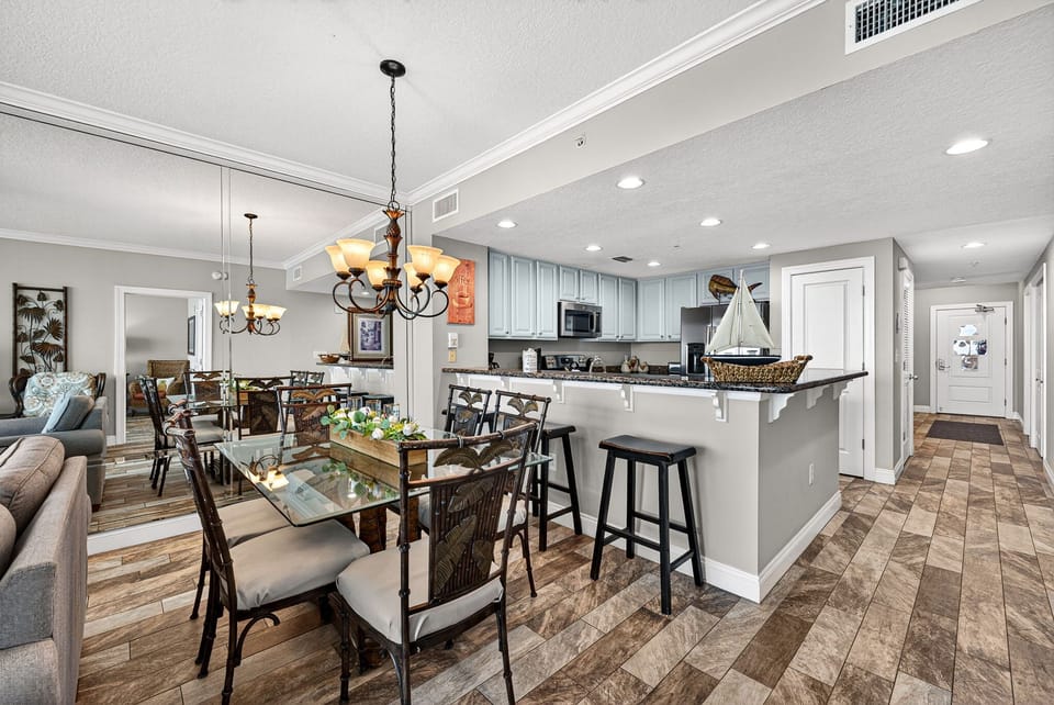 Your open-concept living and dining area flows seamlessly into a fully equipped kitchen, ideal for gathering over home-cooked meals or morning coffee in this bright, inviting space.