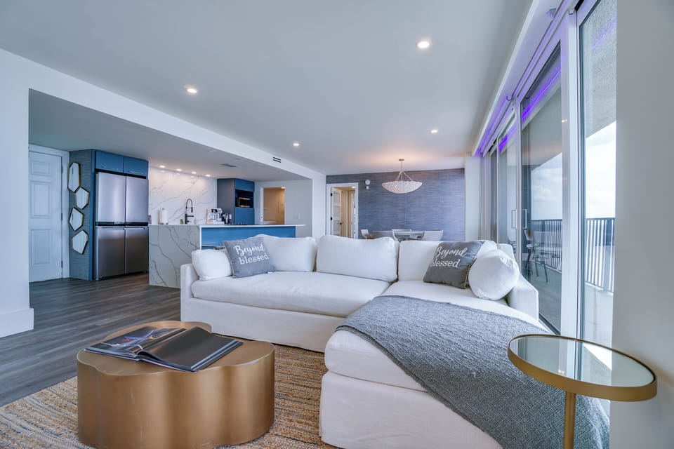 Sink into the plush sectional and let the ocean breeze wash over you. This open-concept space blends modern coastal style with thoughtful comfort, perfect for your beach getaway.
