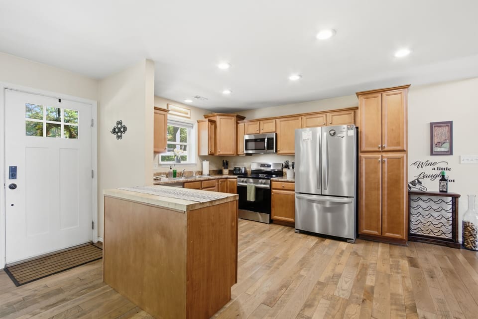 Bright updated kitchen with island, stainless appliances, and ample storage