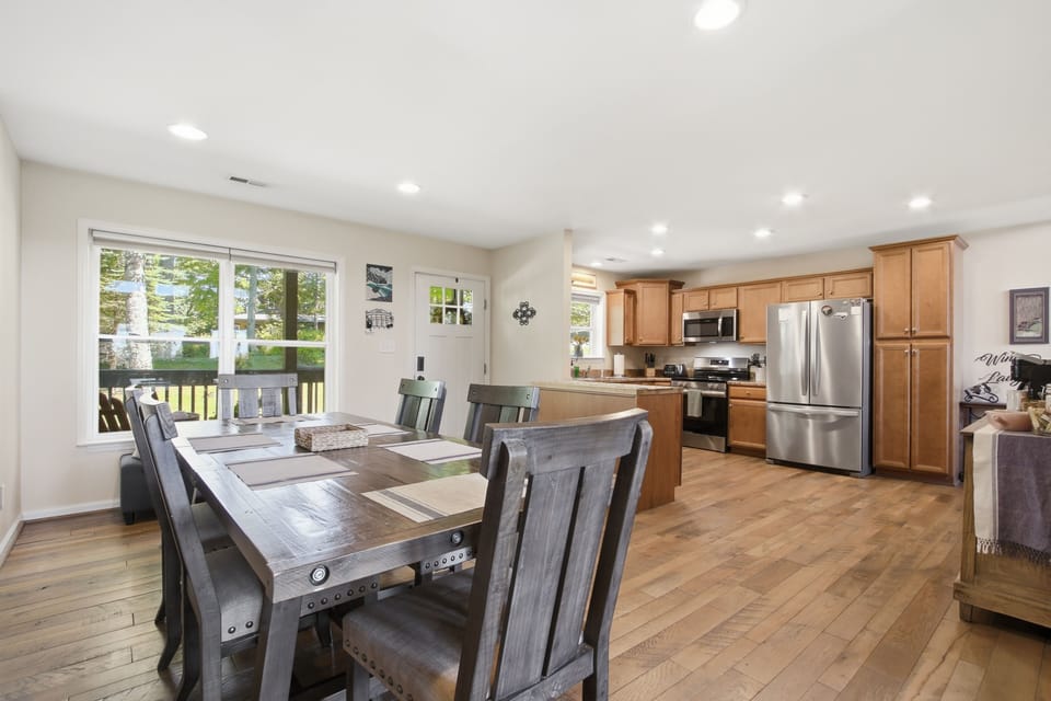 Bright open dining area and full kitchen with deck views