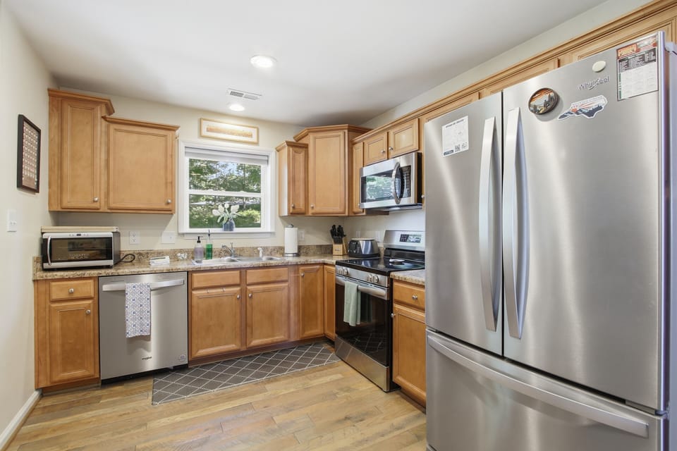 Bright full kitchen with stainless appliances and ample cabinet space