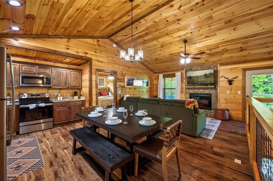 An inviting open-concept space w/ a full kitchen, dining area, and living room.
