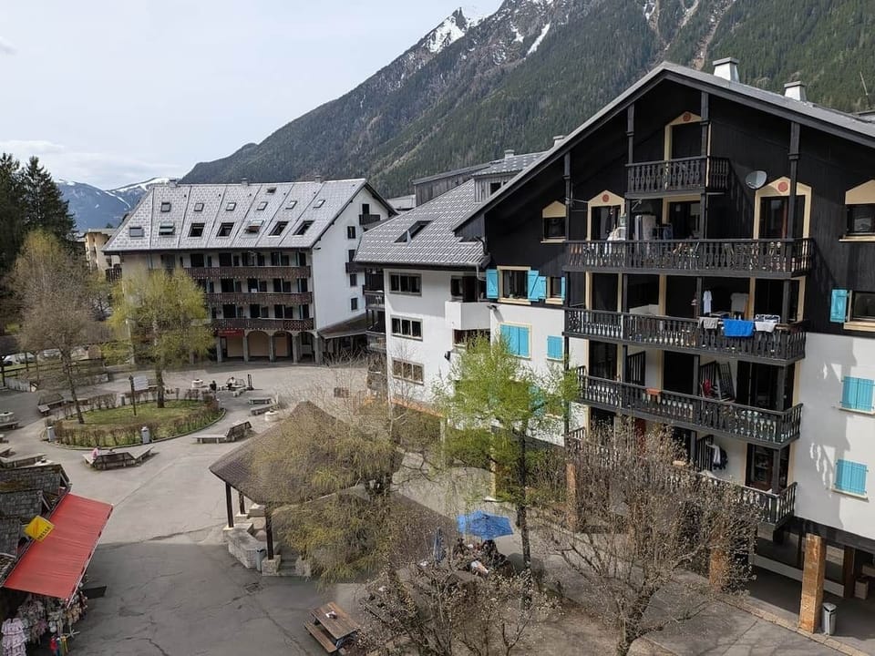 The balcony overlooks a pedestrian square lined with a variety of shops and local amenities.