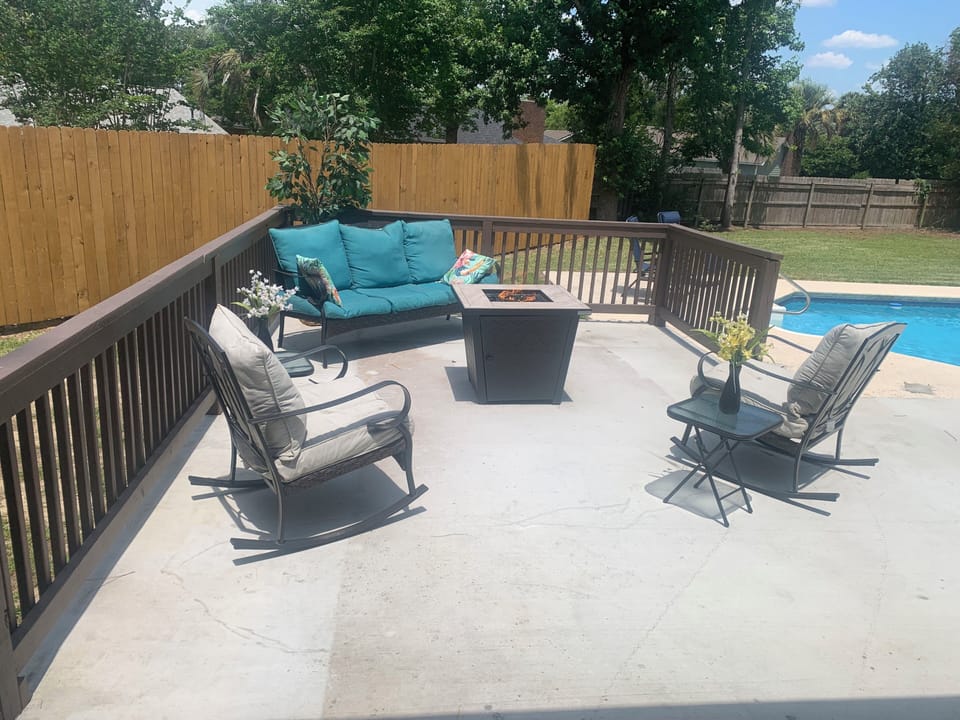 Firepit and seating overlooking the sparkling pool. 