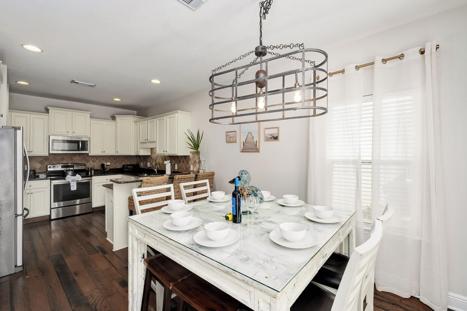 Step into your open-concept kitchen and dining area, where light-filled mornings and cozy dinners await. Gather around the charming farmhouse table, ready for shared meals and memories.