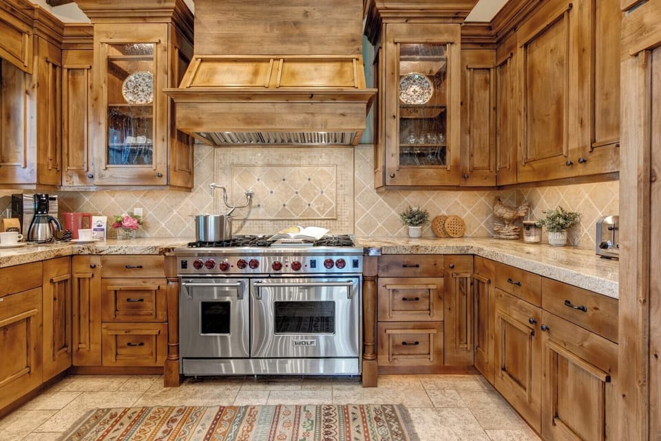 Your chef’s kitchen features high-end appliances, double ovens, and custom wood cabinetry for unforgettable group meals.