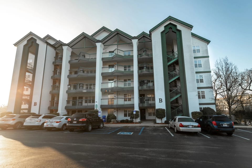Exterior view of the resort building with parking and bare trees.