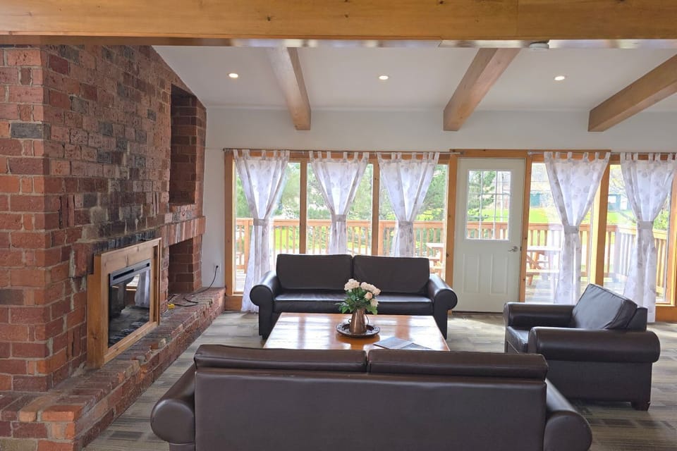 Upper level with the sitting area, smart TV, electric fireplace, dining area and kitchen