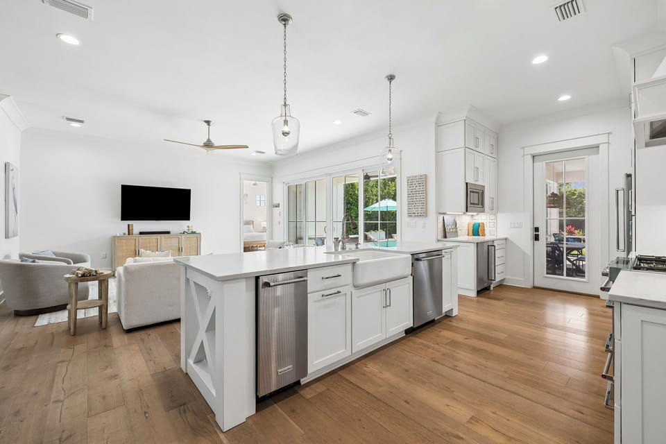 Your spacious, sun-filled kitchen opens to a cozy living area, perfect for preparing meals while staying connected with loved ones in this bright, airy retreat.