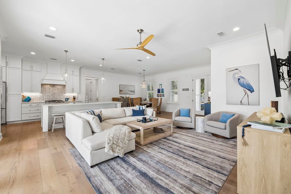 Relax in your bright, open living space where coastal comfort meets modern elegance. Soft seating, warm wood floors, and breezy accents invite you to unwind in style.