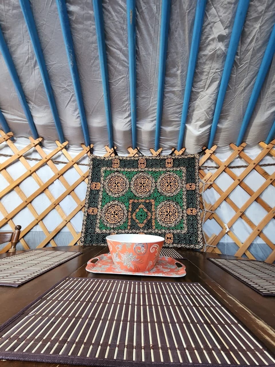 Mongolian tapestry in front of the dining table.
