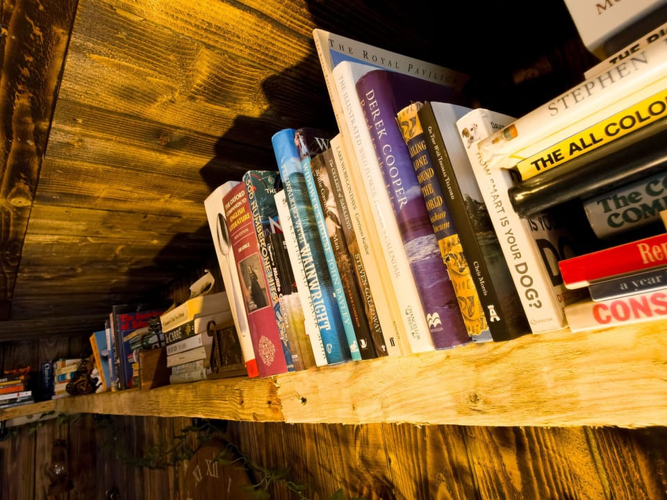 The outdoor snug is stocked with a great selection of books and games — perfect for a cosy Highland evening.