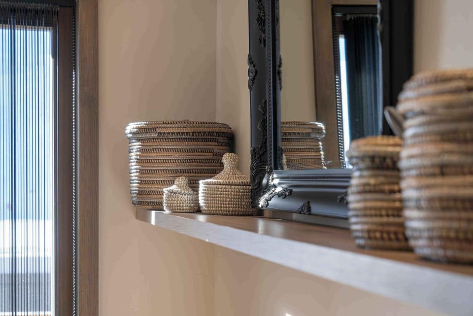 Hand-woven baskets and dark-framed mirrors — South American design details carried throughout the common areas