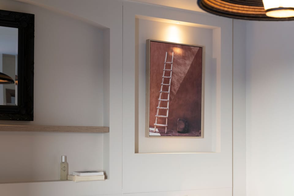 Framed ladder artwork and a styled shelf — the Latin American aesthetic runs through every level